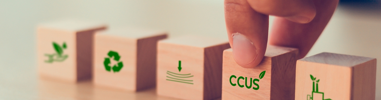 Carbon Capture, Utilization and Storage (CCUS) concept symbolized by five wooden blocks.