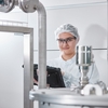 Woman with tablet in a hygienic factory environment